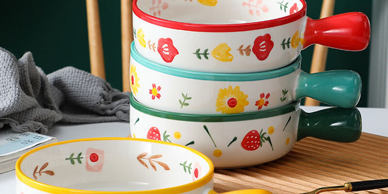 Cute ceramic bowl with colorful handle and printed pattern